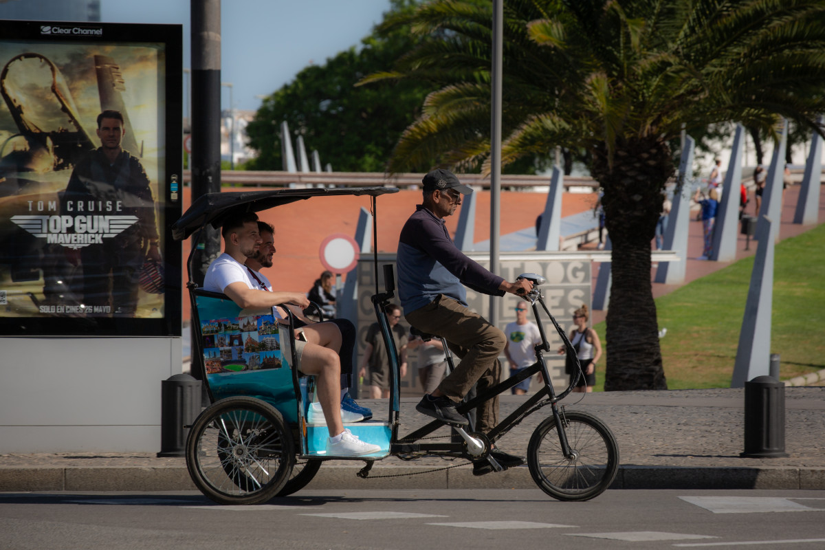 Varias personas montadas en un bicitaxi en el Paseo de Colón de Barcelona, a 30 de mayo de 2022, en Barcelona, Cataluña (España).