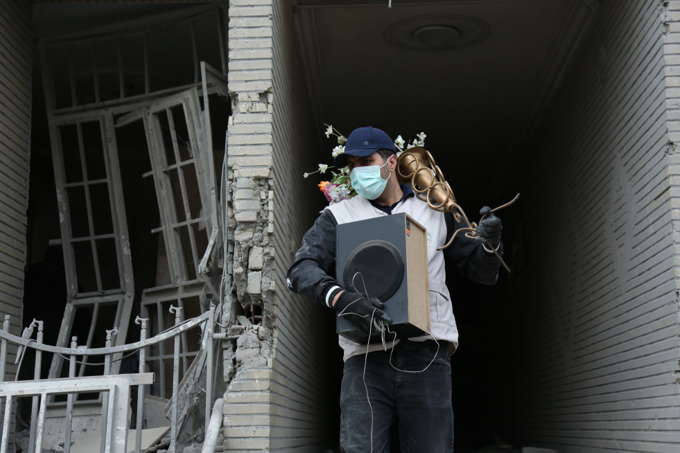 EuropaPress 7367536 beijing march 15 2026    man carries belongings searched from destroyed