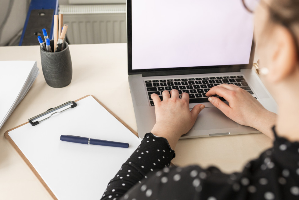 High angle woman working empty display laptop